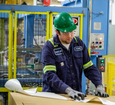 man wearing a hard hat and looking at a paper